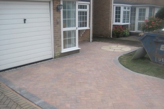 conservatory extension of a family home with leather sofa and tiled floor